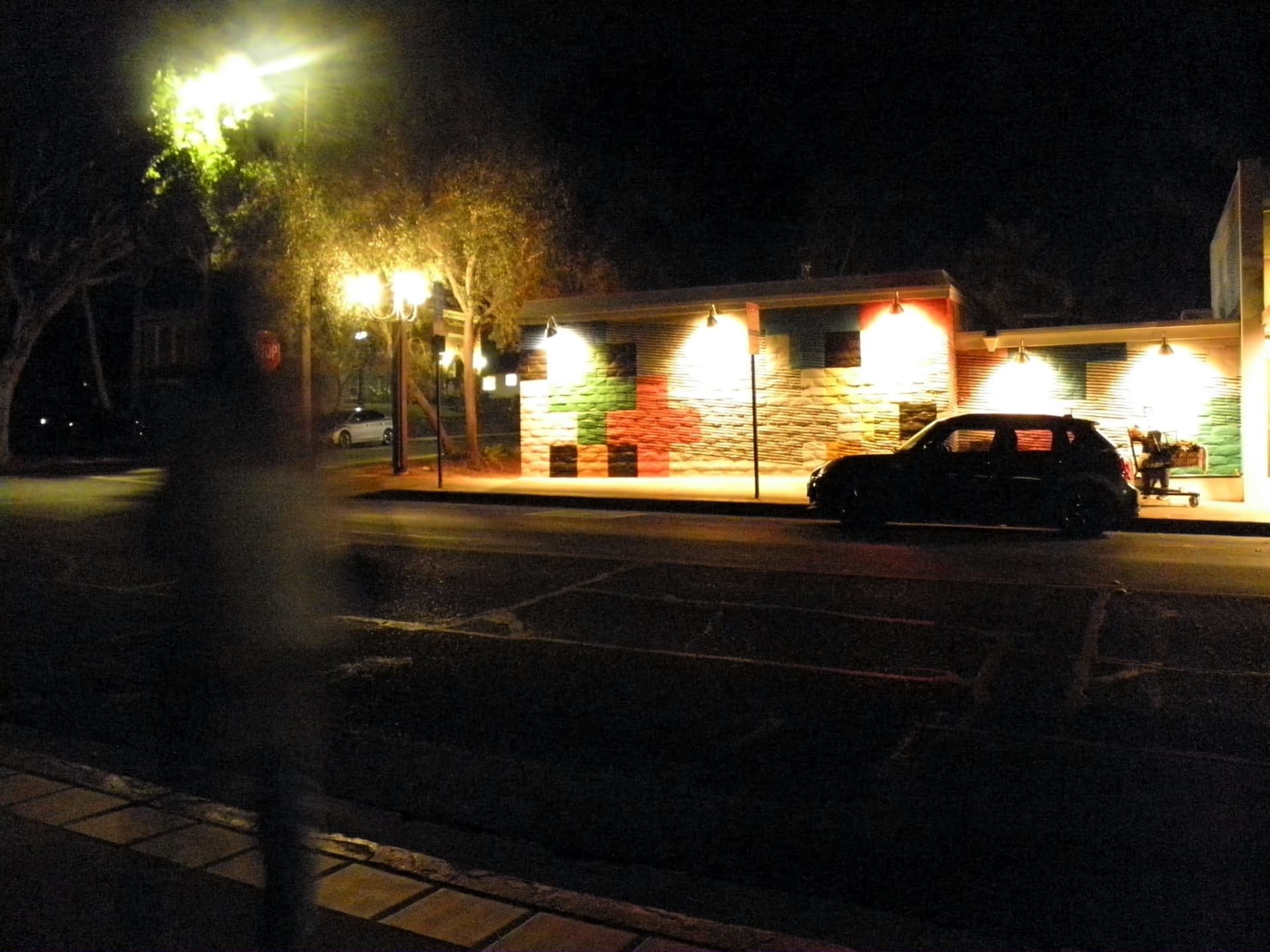 Storefront lit at night with warm lamps