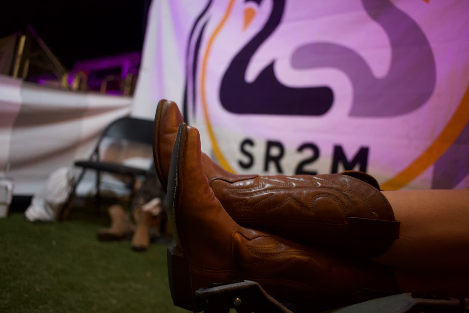 Cowboy boots resting up at an outdoor evening event