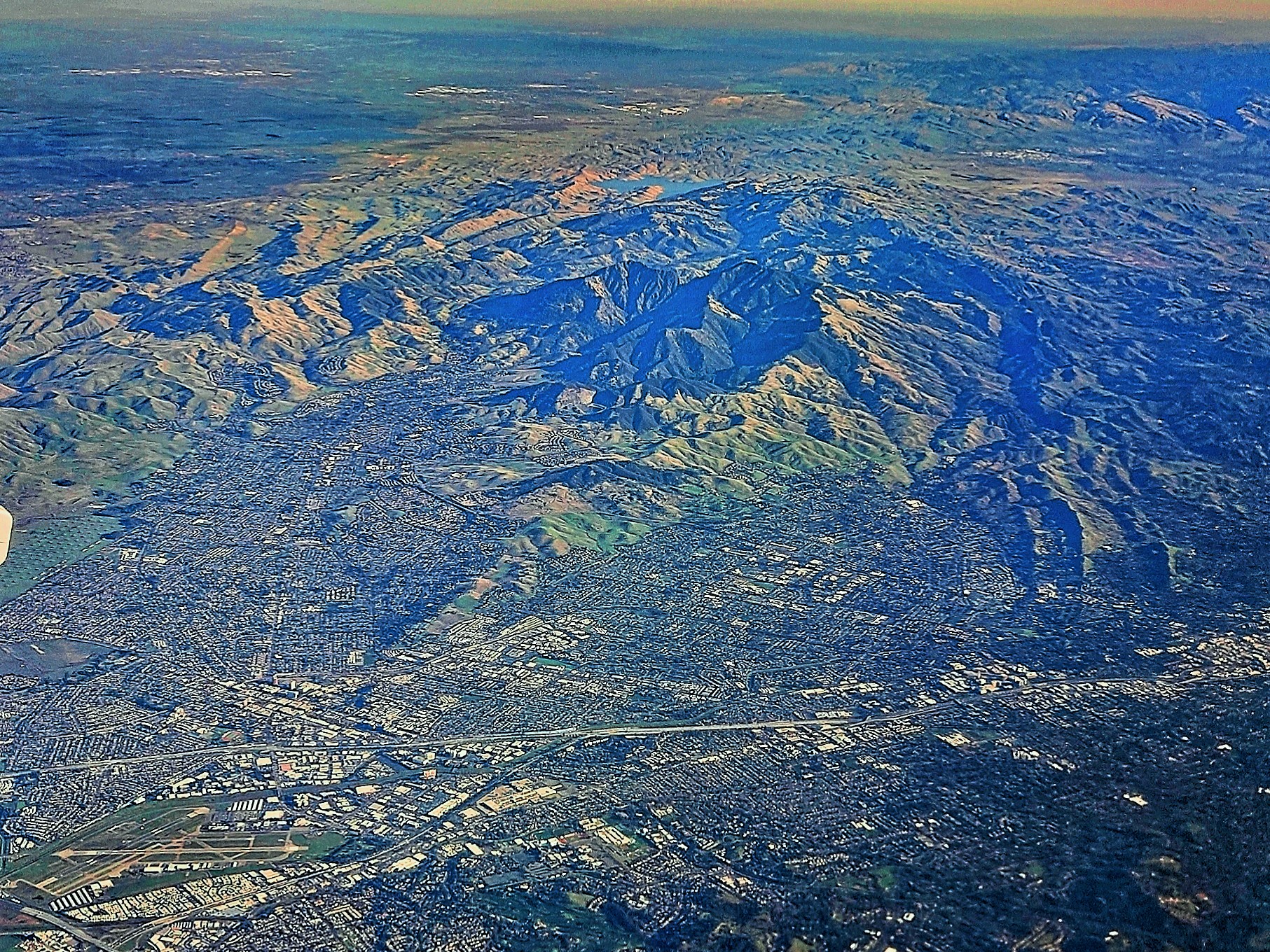 Aerial view of a valley and city at dawn
